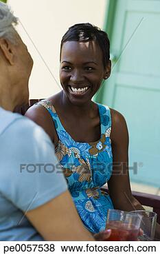 Stock Photo - two women outdoors 
on patio. fotosearch 
- search stock 
photos, pictures, 
images, and photo 
clipart