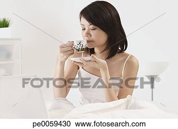 Stock Photography - woman with cup 
of tea and laptop. 
fotosearch - search 
stock photos, 
pictures, images, 
and photo clipart