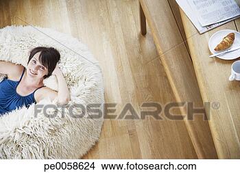 Stock Photo - woman on furry 
bean bag chair 
in living room. 
fotosearch - search 
stock photos, 
pictures, images, 
and photo clipart
