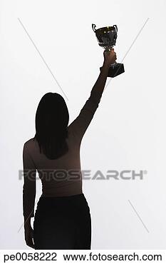 Stock Photo - woman holding 
up a trophy. fotosearch 
- search stock 
photos, pictures, 
images, and photo 
clipart