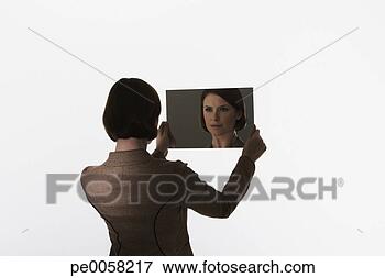 Picture - woman looking 
into a mirror. 
fotosearch - search 
stock photos, 
pictures, images, 
and photo clipart