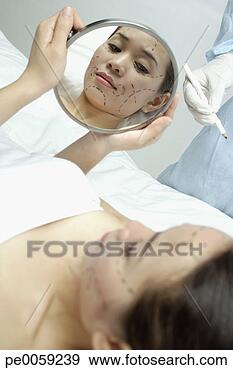 Stock Photograph - woman with plastic 
surgery lines 
drawn on face. 
fotosearch - search 
stock photos, 
pictures, images, 
and photo clipart