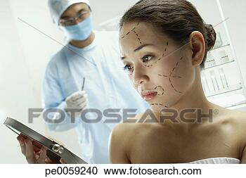 Stock Photography - woman with plastic 
surgery lines 
drawn on face. 
fotosearch - search 
stock photos, 
pictures, images, 
and photo clipart