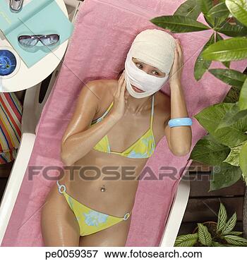 Picture - woman in swimwear 
with face wrapped 
in gauze. fotosearch 
- search stock 
photos, pictures, 
images, and photo 
clipart