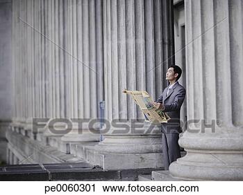 Stock Photography - businessman outdoors 
on steps holding 
newspaper looking 
up. fotosearch 
- search stock 
photos, pictures, 
images, and photo 
clipart