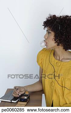 Stock Image - businesswoman 
indoors wearing 
headset blowing 
bubble. fotosearch 
- search stock 
photos, pictures, 
images, and photo 
clipart
