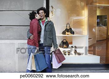 Stock Photo - couple outdoors 
with shopping 
bags kissing. 
fotosearch - search 
stock photos, 
pictures, images, 
and photo clipart