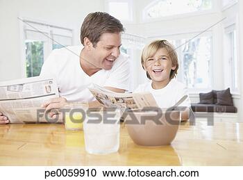 Stock Photography - man and young 
boy in kitchen 
reading newspaper 
and laughing. 
fotosearch - search 
stock photos, 
pictures, images, 
and photo clipart