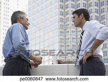 Picture - two businessmen 
outdoors on a 
balcony with coffee 
cups. fotosearch 
- search stock 
photos, pictures, 
images, and photo 
clipart