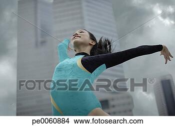 Stock Photo - woman gymnast 
outdoors posing. 
fotosearch - search 
stock photos, 
pictures, images, 
and photo clipart