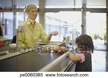Stock Image - young girl at 
grocery store 
check-out. fotosearch 
- search stock 
photos, pictures, 
images, and photo 
clipart
