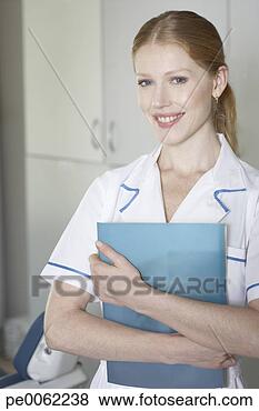 Stock Photo - dental assistant 
standing in examination 
room holding clipboard 
and. fotosearch 
- search stock 
photos, pictures, 
images, and photo 
clipart