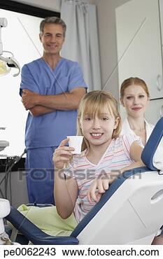 Stock Photo - dentist and dental 
assistant in examination 
room with smiling 
young. fotosearch 
- search stock 
photos, pictures, 
images, and photo 
clipart