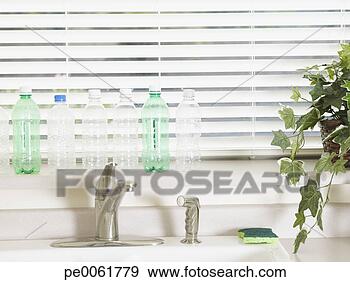Stock Photograph - row of empty plastic 
bottles by a kitchen 
window. fotosearch 
- search stock 
photos, pictures, 
images, and photo 
clipart