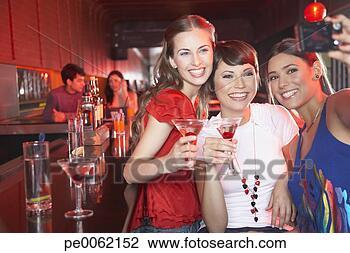 Stock Photo - three women in 
nightclub with 
beverages taking 
self-portrait 
with. fotosearch 
- search stock 
photos, pictures, 
images, and photo 
clipart