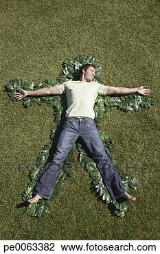 Stock Photo - man laying in 
grass outlined 
by green leaves. 
fotosearch - search 
stock photos, 
pictures, images, 
and photo clipart