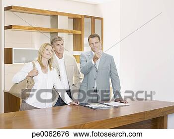Stock Photo - salesman with 
couple in interior 
design showroom. 
fotosearch - search 
stock photos, 
pictures, images, 
and photo clipart