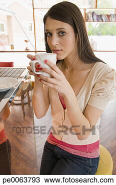 Stock Photo - teenage girl drinking 
warm drink in 
cafe. fotosearch 
- search stock 
photos, pictures, 
images, and photo 
clipart