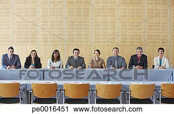 Stock Photography - businesspeople 
sitting at table 
smiling. fotosearch 
- search stock 
photos, pictures, 
images, and photo 
clipart