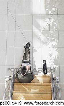 Stock Photograph - aerial view of 
businessman sitting 
on stairs with 
laptop and briefcase. 
fotosearch - search 
stock photos, 
pictures, images, 
and photo clipart