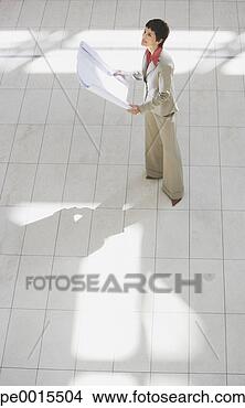 Stock Photo - aerial view of 
businesswoman 
with blueprints. 
fotosearch - search 
stock photos, 
pictures, images, 
and photo clipart