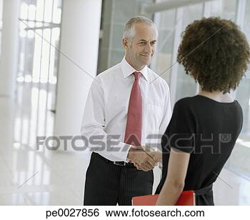 Stock Photo - businesswoman 
with document 
shaking hands 
with businessman. 
fotosearch - search 
stock photos, 
pictures, images, 
and photo clipart