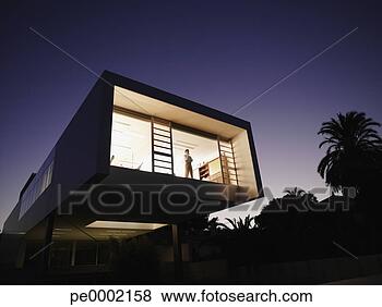 Stock Photo - exterior of a 
modern office 
building with 
man looking out 
window. fotosearch 
- search stock 
photos, pictures, 
images, and photo 
clipart