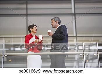 Stock Photograph - low angle view 
of businessman 
and businesswoman 
with document. 
fotosearch - search 
stock photos, 
pictures, images, 
and photo clipart