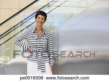 Stock Photo - woman in front 
of escalator. 
fotosearch - search 
stock photos, 
pictures, images, 
and photo clipart