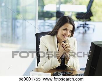 Stock Image - woman in office 
working on her 
personal computer. 
fotosearch - search 
stock photos, 
pictures, images, 
and photo clipart