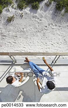 Stock Photo - aerial view of 
man and woman 
sitting outdoors 
with wine and 
sand. fotosearch 
- search stock 
photos, pictures, 
images, and photo 
clipart