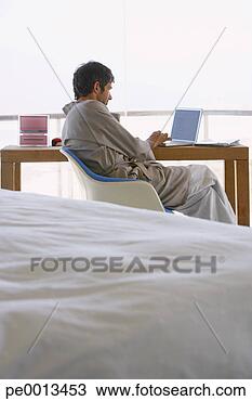 Stock Photo - man in robe with 
laptop. fotosearch 
- search stock 
photos, pictures, 
images, and photo 
clipart
