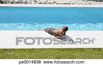 Stock Photo - man sunbathing 
with feet in pool. 
fotosearch - search 
stock photos, 
pictures, images, 
and photo clipart