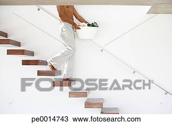 Stock Photo - man walking down 
stairs with laundry 
basket. fotosearch 
- search stock 
photos, pictures, 
images, and photo 
clipart