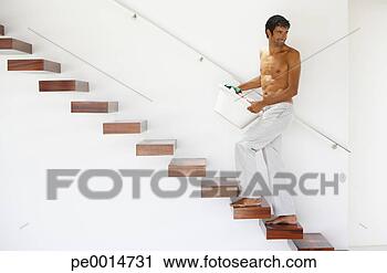Stock Photography - man walking up 
stairs with laundry 
basket. fotosearch 
- search stock 
photos, pictures, 
images, and photo 
clipart