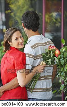 Stock Photo - man and woman 
outdoors with 
flowers embracing. 
fotosearch - search 
stock photos, 
pictures, images, 
and photo clipart