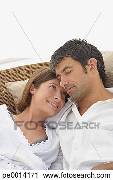 Stock Photography - man and woman 
snuggling and 
smiling. fotosearch 
- search stock 
photos, pictures, 
images, and photo 
clipart