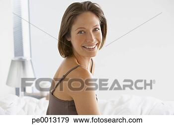 Stock Photograph - woman indoors 
smiling. fotosearch 
- search stock 
photos, pictures, 
images, and photo 
clipart