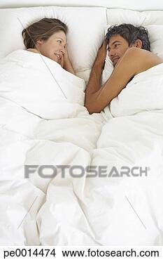 Stock Photo - woman and man 
lying down in 
bed. fotosearch 
- search stock 
photos, pictures, 
images, and photo 
clipart