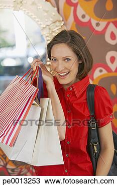 Stock Photo - woman with shopping 
bags smiling. 
fotosearch - search 
stock photos, 
pictures, images, 
and photo clipart
