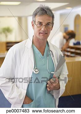 Stock Photo - male doctor with 
clipboard and 
stethoscope in 
hospital. fotosearch 
- search stock 
photos, pictures, 
images, and photo 
clipart