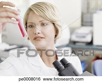 Stock Photo - woman with eyeglasses 
looking at test 
tube. fotosearch 
- search stock 
photos, pictures, 
images, and photo 
clipart