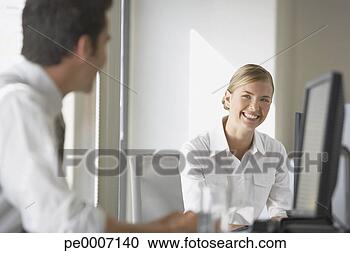 Stock Photography - two business colleagues 
talking. fotosearch 
- search stock 
photos, pictures, 
images, and photo 
clipart