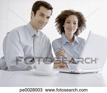 Stock Photo - businessman and 
woman with laptop. 
fotosearch - search 
stock photos, 
pictures, images, 
and photo clipart