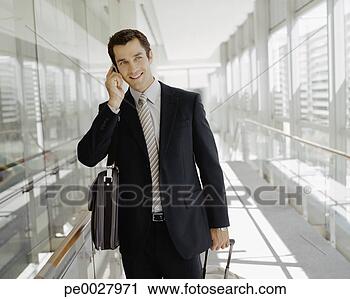 Stock Photography - male business 
traveler talking 
on cell phone. 
fotosearch - search 
stock photos, 
pictures, images, 
and photo clipart