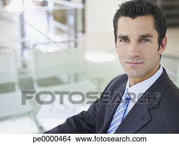 Stock Photo - portrait of a 
businessman sitting 
at desk. fotosearch 
- search stock 
photos, pictures, 
images, and photo 
clipart