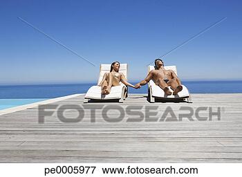 Picture - man and woman 
in deck chairs 
sunbathing holding 
hands. fotosearch 
- search stock 
photos, pictures, 
images, and photo 
clipart