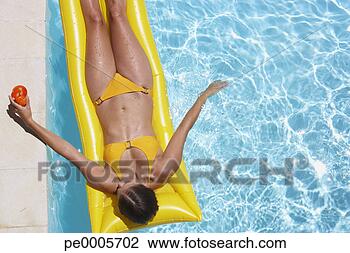 Stock Photo - woman in bikini 
on flotation device 
in pool with beverage. 
fotosearch - search 
stock photos, 
pictures, images, 
and photo clipart