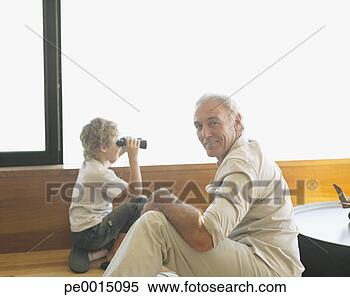 Stock Image - grandfather with 
grandson and binoculars. 
fotosearch - search 
stock photos, 
pictures, images, 
and photo clipart