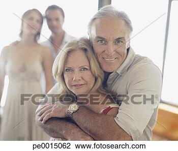 Stock Photo - mature couple 
with younger couple 
in background. 
fotosearch - search 
stock photos, 
pictures, images, 
and photo clipart